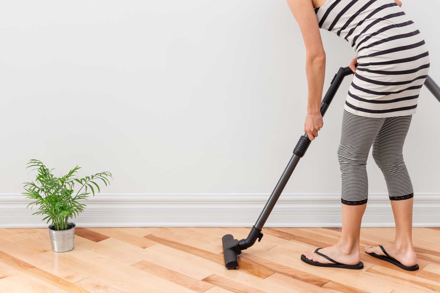 Regulary vacuum or sweep floors to remove dirt and keep your home floors looking amazing - tips from Footprints Floors in Peachtree City.